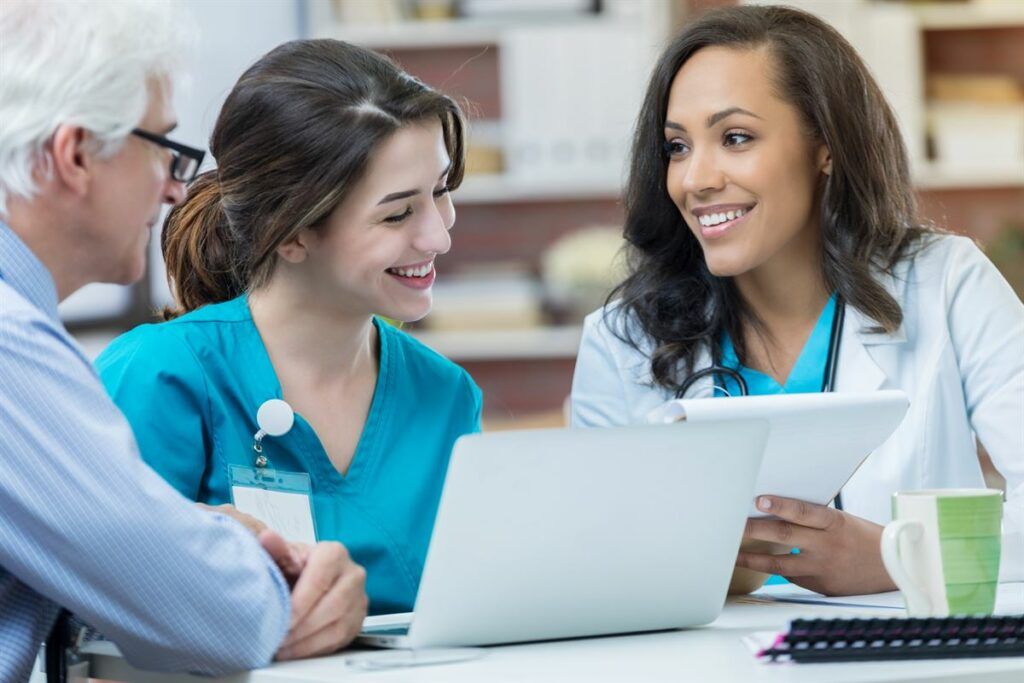 African American and Asian nurses discussing a medical chart